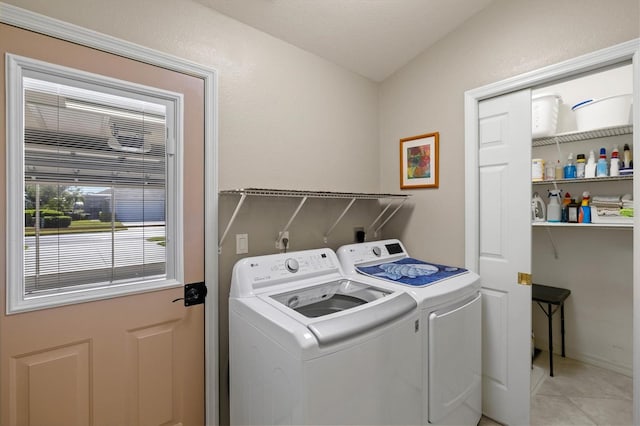 washroom featuring laundry area, light tile patterned floors, and washer and dryer