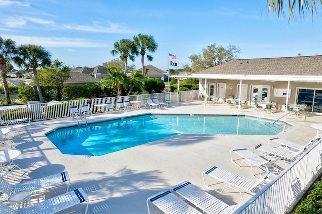 pool with fence and a patio