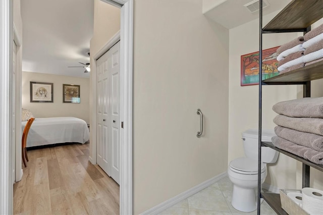 bedroom featuring light wood-style flooring, a closet, visible vents, and baseboards