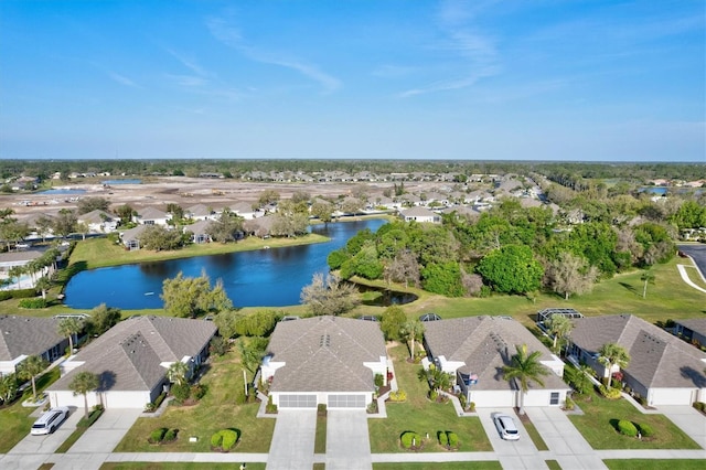 drone / aerial view featuring a water view and a residential view