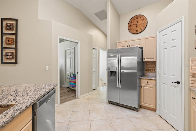 kitchen featuring stainless steel appliances, light brown cabinets, visible vents, and light tile patterned floors