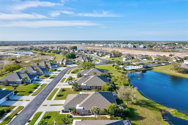 drone / aerial view with a water view and a residential view