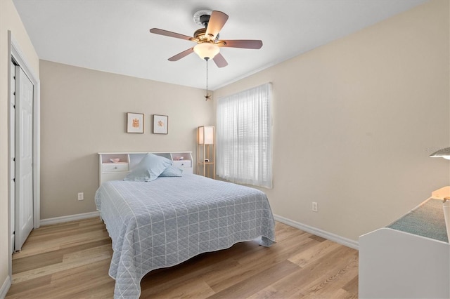 bedroom featuring a closet, wood finished floors, a ceiling fan, and baseboards