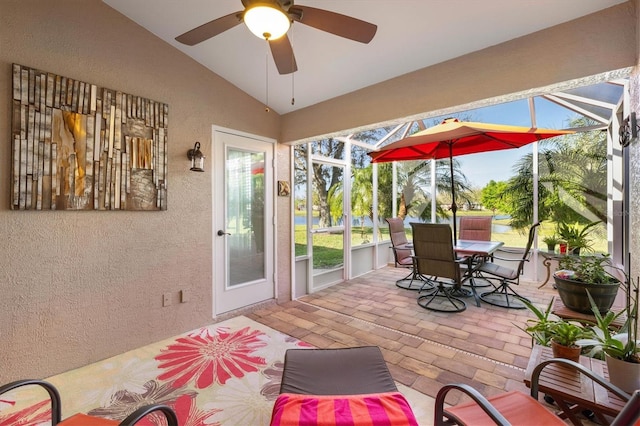 sunroom with a ceiling fan and vaulted ceiling