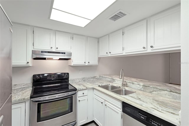 kitchen with light stone countertops, sink, white cabinets, and appliances with stainless steel finishes