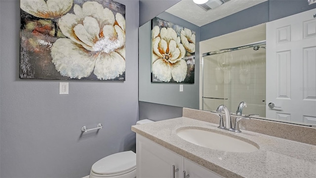 bathroom featuring walk in shower, vanity, and toilet