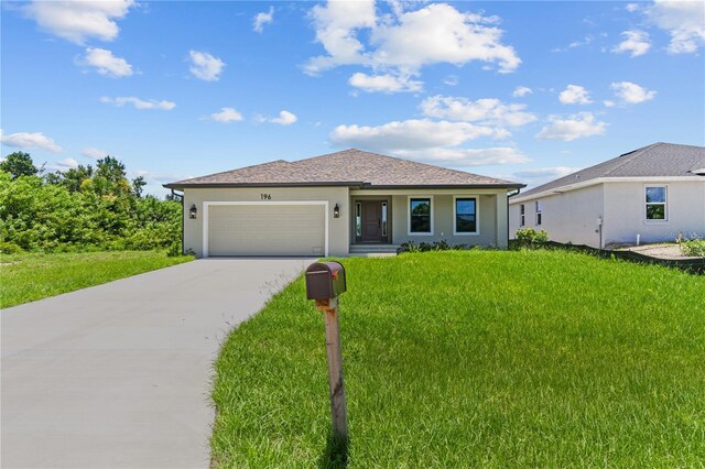 view of front of home featuring a garage and a front yard