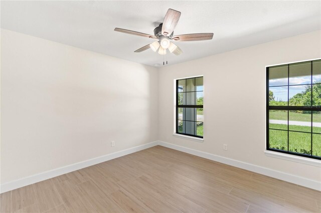 spare room featuring ceiling fan and light wood-type flooring