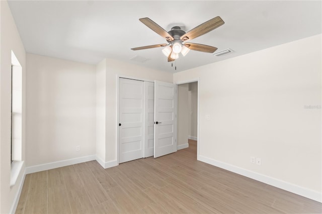 unfurnished bedroom with a closet, ceiling fan, and light wood-type flooring