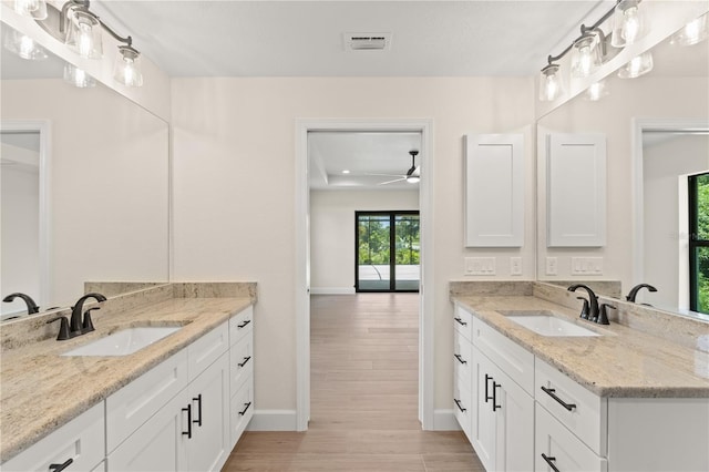 bathroom featuring two vanities, visible vents, and a sink