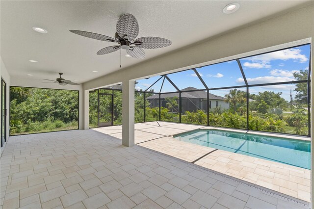 outdoor pool with a patio area, ceiling fan, and a lanai