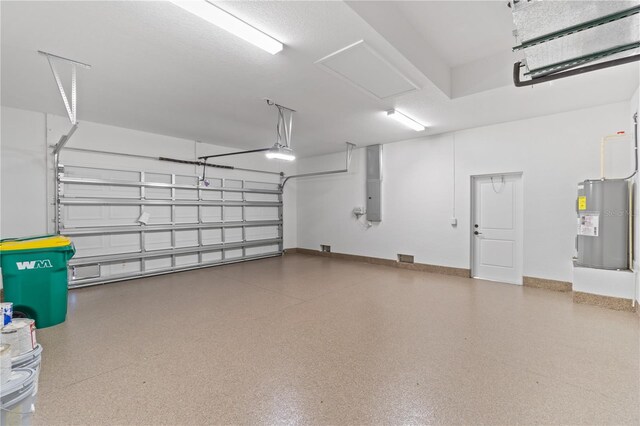 garage with water heater and a garage door opener