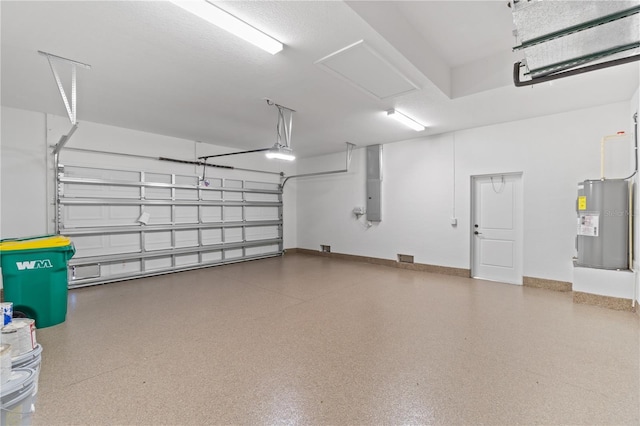 garage with baseboards and water heater