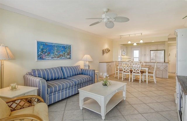 living room with light tile flooring, ornamental molding, ceiling fan, and track lighting