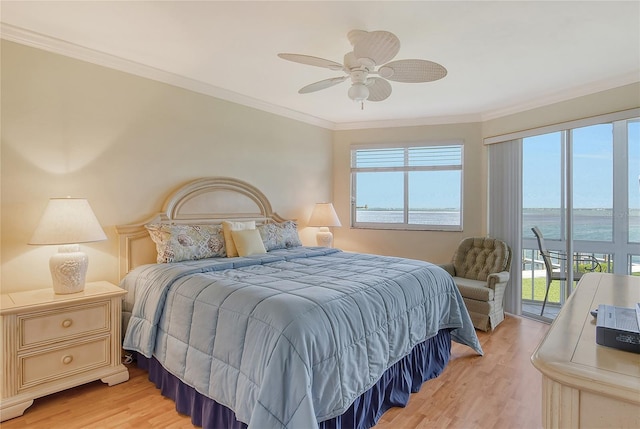 bedroom featuring light hardwood / wood-style floors, access to exterior, ceiling fan, ornamental molding, and a water view