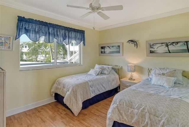 bedroom with light hardwood / wood-style floors, ceiling fan, and crown molding