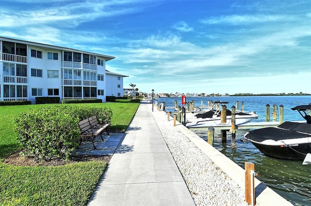 dock area featuring a balcony and a water view