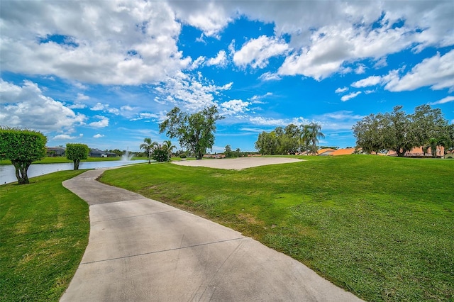 view of property's community featuring a yard and a water view