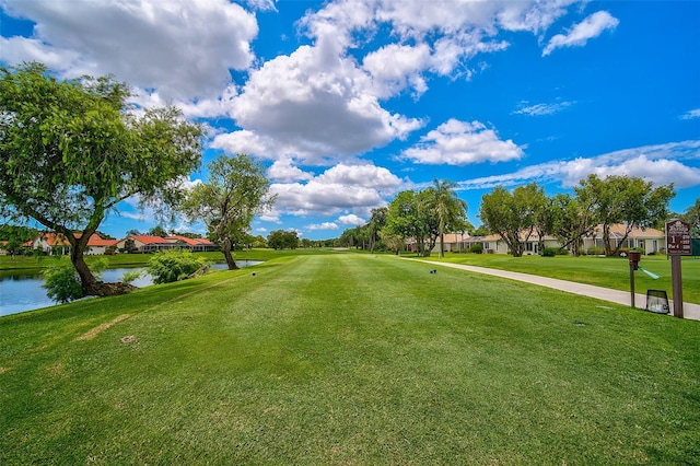 view of home's community with a yard and a water view