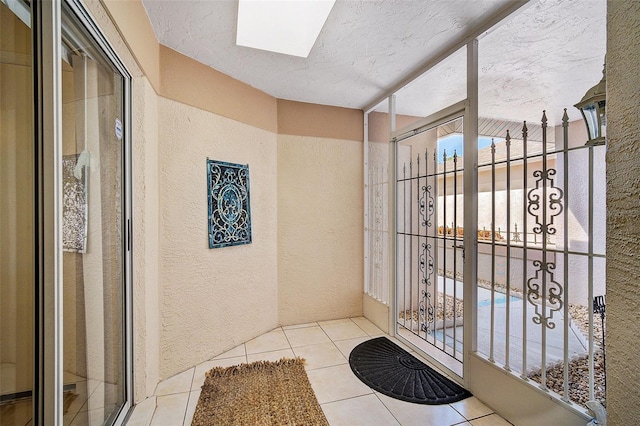 bathroom with a textured ceiling and tile patterned floors