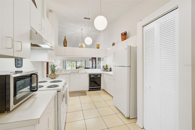 kitchen featuring white appliances, pendant lighting, light tile patterned floors, high vaulted ceiling, and white cabinetry