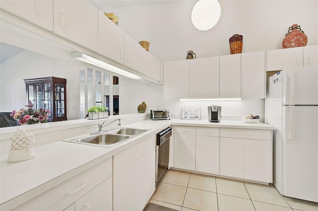 kitchen with sink, white refrigerator, white cabinetry, and dishwasher