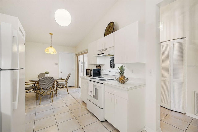 kitchen featuring white appliances, light tile patterned floors, pendant lighting, white cabinetry, and lofted ceiling