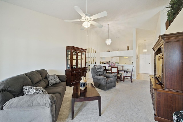 carpeted living room featuring high vaulted ceiling and ceiling fan