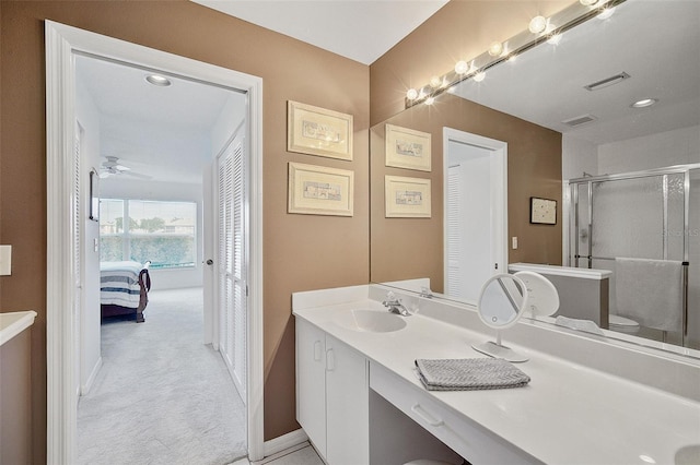 bathroom with toilet, an enclosed shower, vanity, and ceiling fan