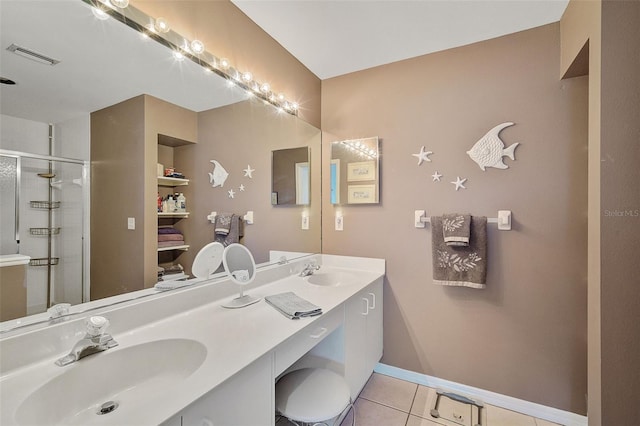 bathroom featuring tile patterned floors, walk in shower, and vanity