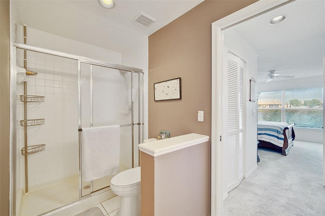 bathroom with ceiling fan, an enclosed shower, and toilet