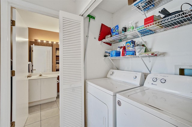 laundry room featuring independent washer and dryer and light tile patterned floors