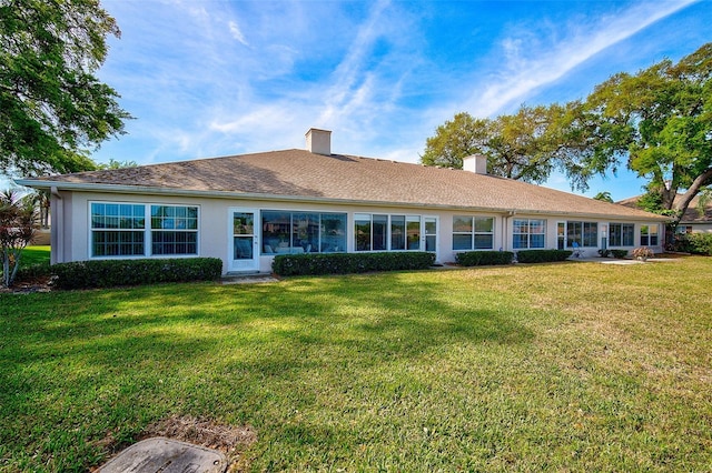 back of house featuring a yard