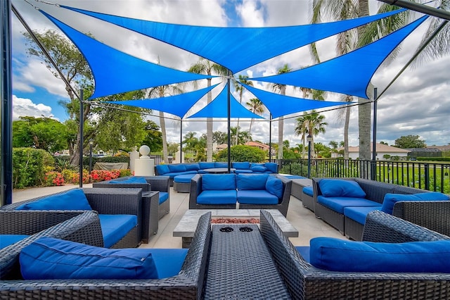 view of patio / terrace with an outdoor living space with a fire pit