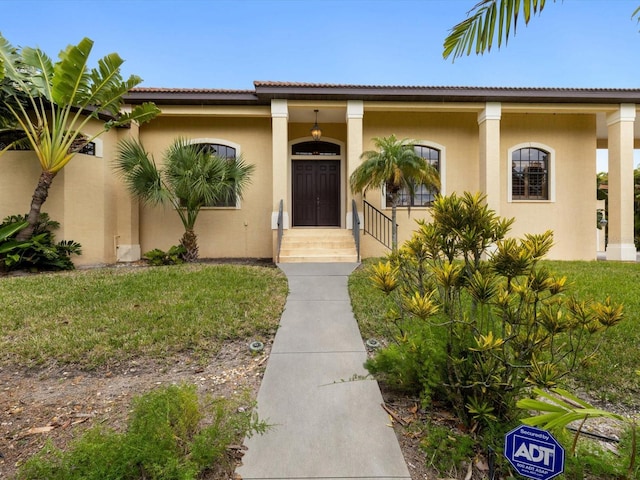 mediterranean / spanish-style house featuring a porch and a front yard