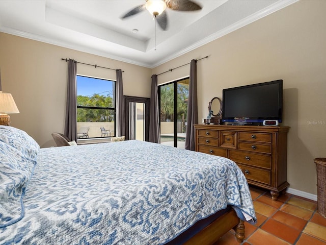 bedroom featuring access to outside, multiple windows, ceiling fan, and a raised ceiling