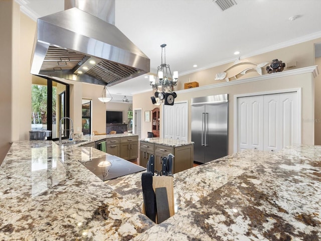 kitchen with sink, ventilation hood, a chandelier, light stone countertops, and stainless steel built in refrigerator