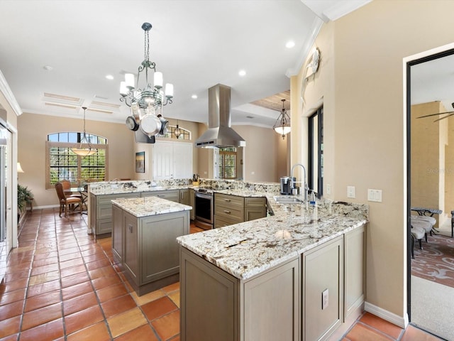 kitchen with light tile floors, kitchen peninsula, sink, and island exhaust hood