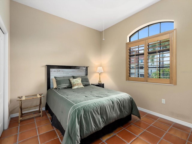 bedroom with dark tile flooring