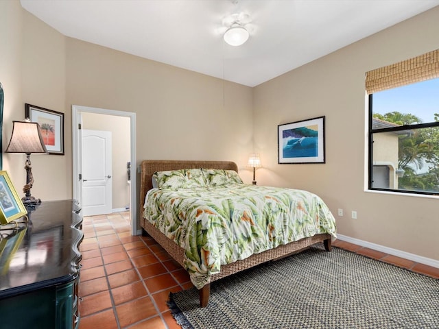 tiled bedroom featuring ceiling fan