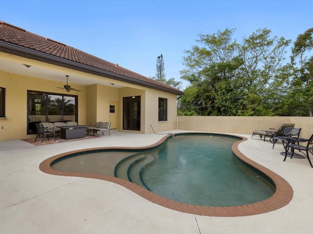 view of swimming pool featuring ceiling fan and a patio