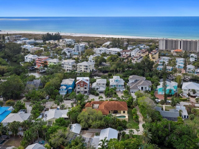 drone / aerial view featuring a beach view and a water view