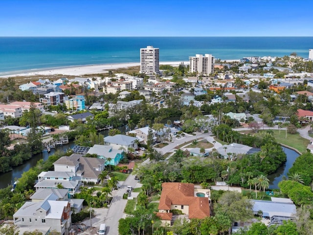 birds eye view of property with a water view and a view of the beach