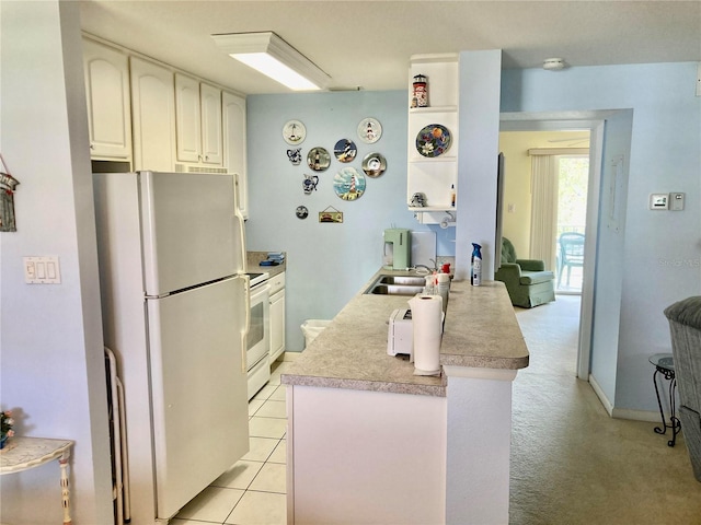 kitchen featuring white cabinets, kitchen peninsula, white appliances, and light tile patterned floors