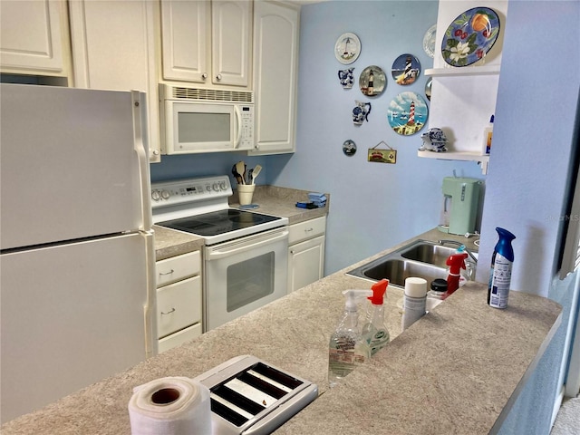 kitchen featuring white appliances, white cabinetry, and sink