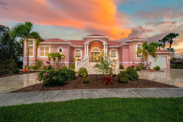 mediterranean / spanish-style home with a garage