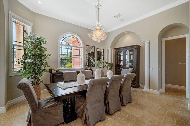 dining room featuring ornamental molding, decorative columns, light tile floors, and an inviting chandelier