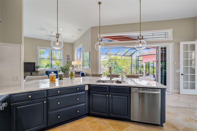 kitchen with sink, light stone counters, hanging light fixtures, stainless steel dishwasher, and light tile flooring