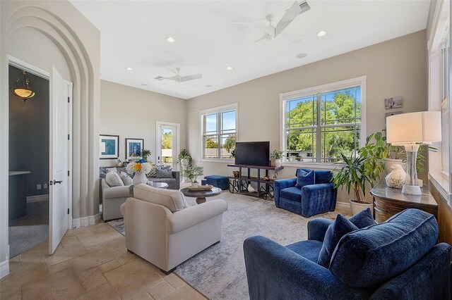 living room with light tile floors and ceiling fan