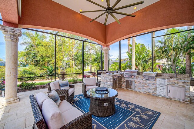 sunroom / solarium with ornate columns and ceiling fan